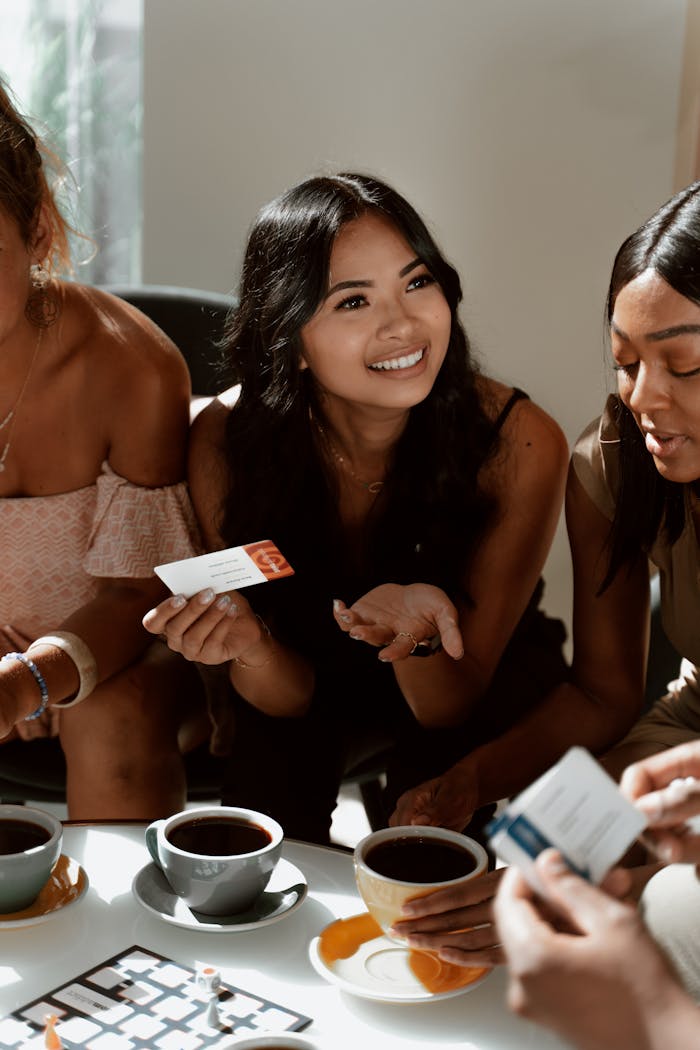 Happy group of friends enjoying a lively conversation over coffee indoors.